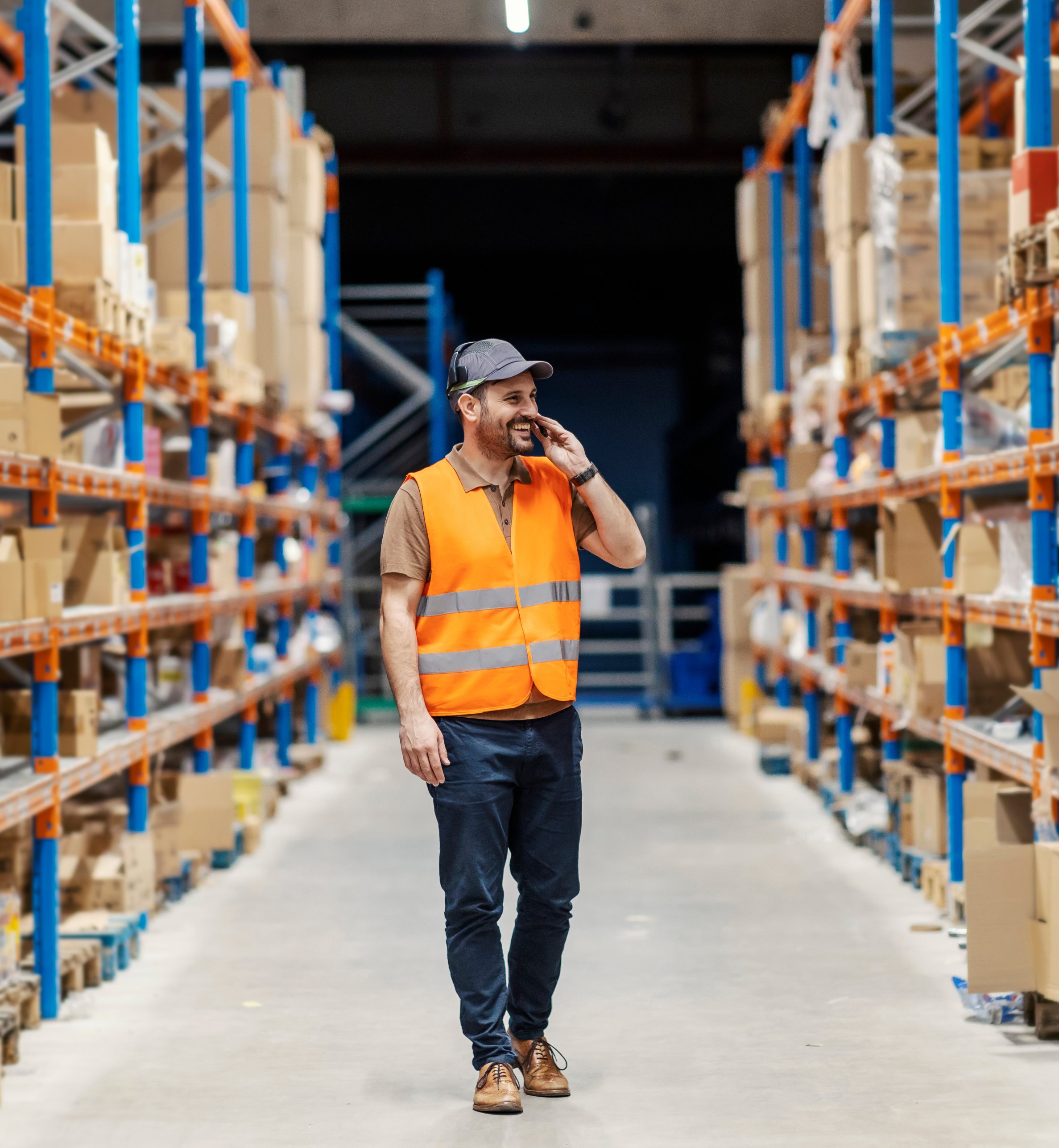 Warehouse vendor on the phone among inventory racks
